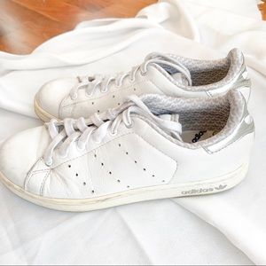 Adidas Stan Smith white silver leather shoes.